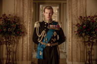 This image released by Netflix shows Matt Smith as Prince Philip from "The Crown." Britain's Prince Philip stood loyally behind behind Queen Elizabeth, as his character does on Netflix's “The Crown.” But how closely does the TV character match the real prince, who died Friday, April 9, 2021 at 99? Philip is depicted as a man of action in “The Crown,” and he served with distinction in the navy in World War II. He was also an avid yachtsman and polo player. (Netflix via AP)
