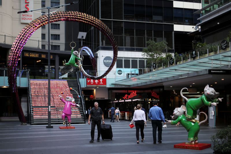 People walk by an area of the city following the implementation of stricter social-distancing and self-isolation rules to limit the spread of the coronavirus disease (COVID-19) in Sydney