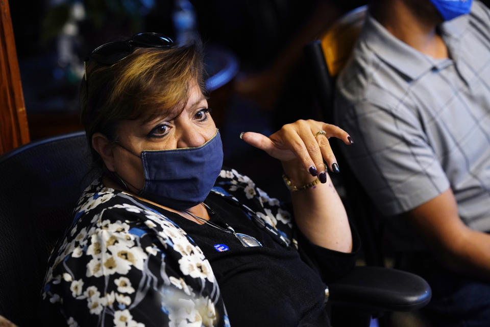 Betty Rangel, daughter of Saul and Carolina Sanchez, talks about her father's death from COVID-19, during an interview Monday, Oct. 12, 2020, in the family home in Greeley, Colo. (AP Photo/David Zalubowski)