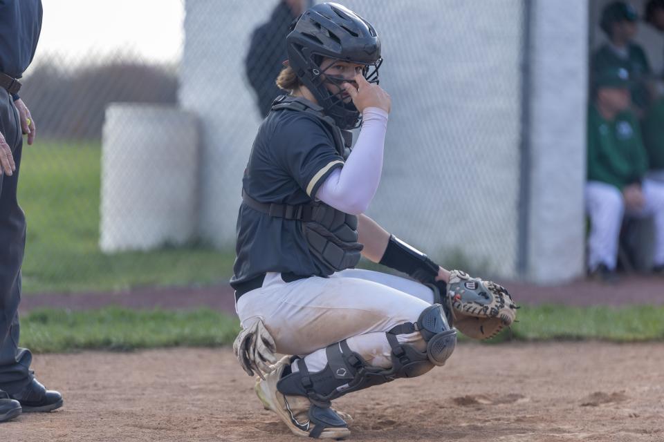 New Brighton Catcher Brock Budacki (0) awaits the pitch call from manager Bob Zahn during the Lions WPIAL Class 2A Section II battle against Laurel on April 22.