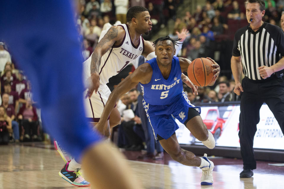 Texas A&M guard Savion Flagg (1) tries to steal the ball from Kentucky guard Immanuel Quickley (5) during the second half of an NCAA college basketball game Tuesday, Feb. 25, 2020, in College Station, Texas. (AP Photo/Sam Craft)