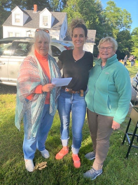 Barbara Fleming and Carol Sanderson of the Greenland Women's Club present Jenna Raizes with the 2022 Greenland Citizen of the Year award.