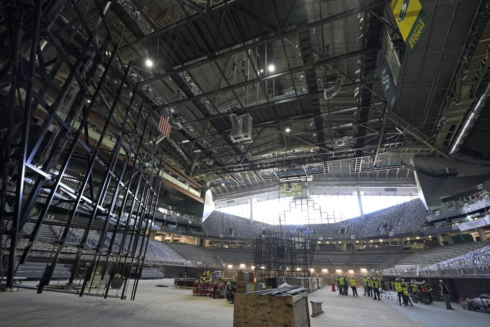 Visitors view construction progress of the Climate Pledge Arena during a media tour of the facility, Monday, July 12, 2021, in Seattle. The arena will be the home of the NHL hockey team Seattle Kraken and the WNBA Seattle Storm basketball team as well as hosting concerts and other performing arts events. (AP Photo/Ted S. Warren)