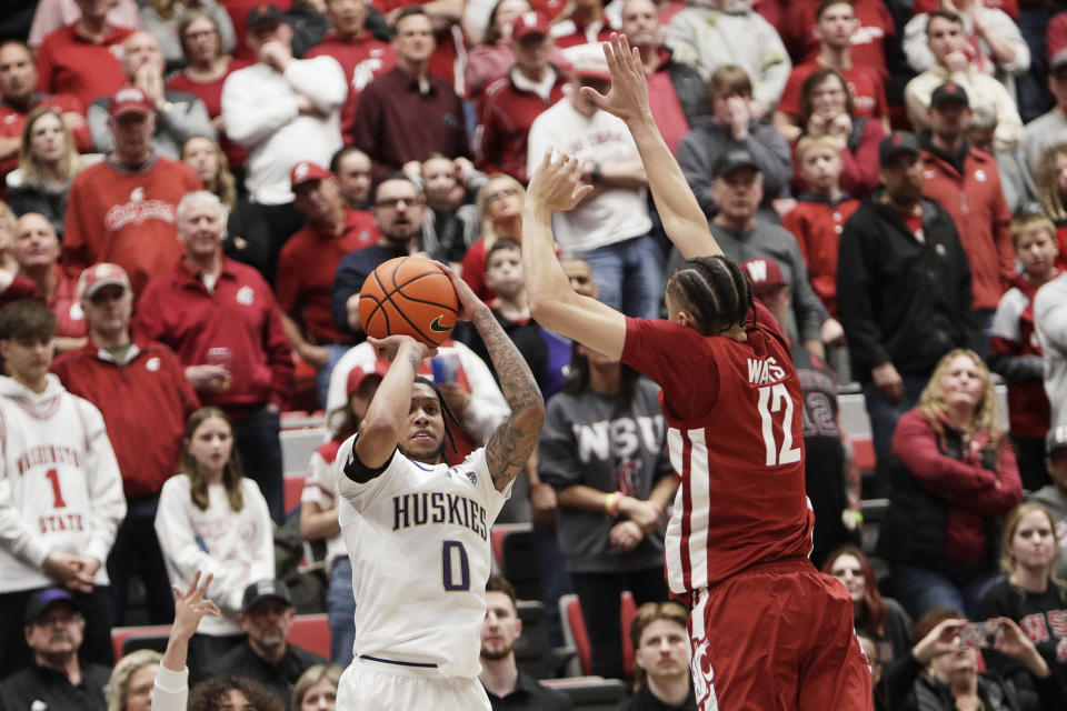 Washington guard Koren Johnson (0) looks to shoot while pressured by Washington State guard Isaiah Watts (12) during the second half of an NCAA college basketball game, Thursday, March 7, 2024, in Pullman, Wash. (AP Photo/Young Kwak)