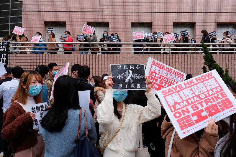 Medical workers hold a strike outside the Hospital Authority as they demand for Hong Kong to close its border with China to reduce the coronavirus spreading, in Hong Kong