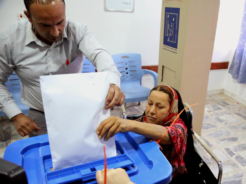 An Iraqi patient casts her vote at a polling center inside al-Kindi hospital in Baghdad, Iraq, Monday, April 28, 2014. Amid tight security, some one million Iraqi army and police personnel have started voting for the nation's new parliament. (AP Photo/ Karim Kadim)