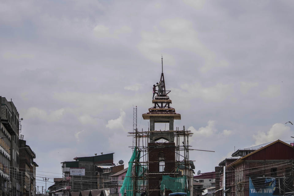 Workers renovate iconic clock tower of Kashmir ahead of G20 tourism working group meeting in Srinagar Indian controlled Kashmir, Thursday, May 18, 2023. Indian authorities have stepped up security and deployed elite commandos to prevent rebel attacks during the meeting of officials from the Group of 20 industrialized and developing nations in the disputed region next week. (AP Photo/Mukhtar Khan)