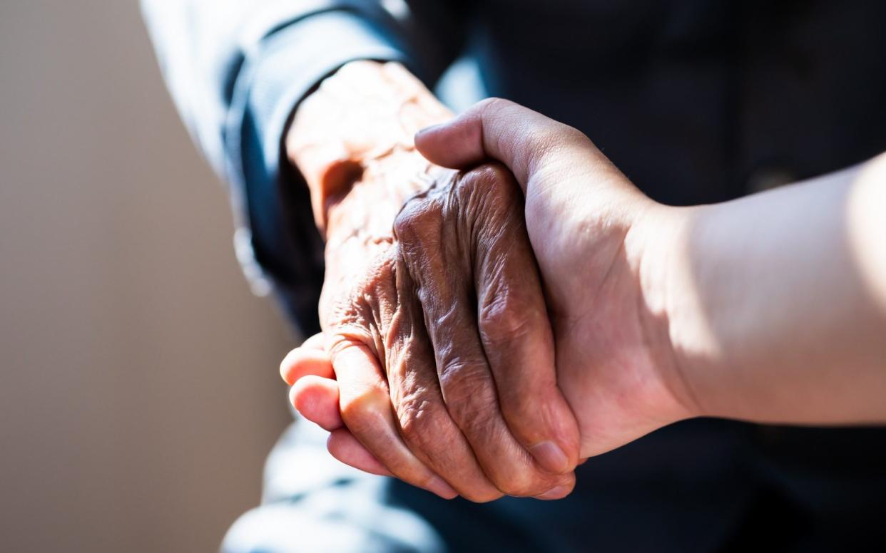 Two people holding hands