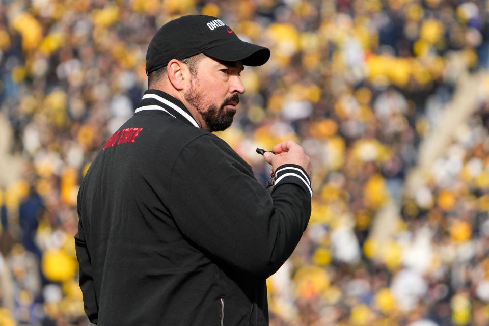 Nov 25, 2023; Ann Arbor, Michigan, USA; Ohio State Buckeyes head coach Ryan Day leads his team in warm-ups prior to the NCAA football game against the Michigan Wolverines at Michigan Stadium.