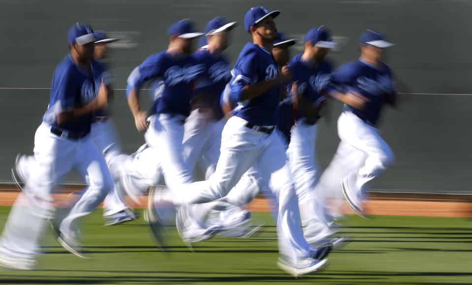 Los Angeles Dodgers pitchers run during spring training baseball practice Tuesday, Feb. 11, 2014, in Glendale, Ariz. (AP Photo/Paul Sancya)
