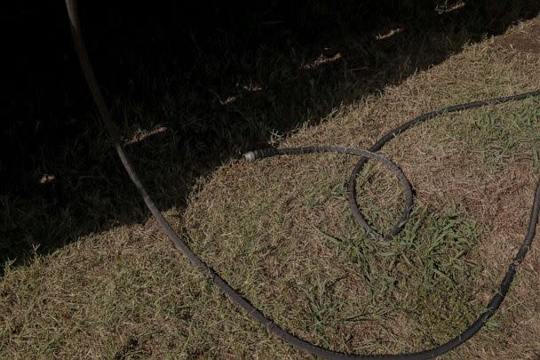 PHOTO: A water hose lays at a mobile water filling station for residents during a heatwave and water outages in Bixby, Okla., July 19, 2022.  (Bloomberg via Getty Images, FILE)