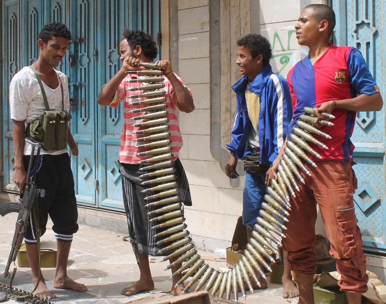 Yemeni fighters opposing the Huthi rebels hold a bullet belt in the northern entrance of the southern city of Aden on April 8, 2015