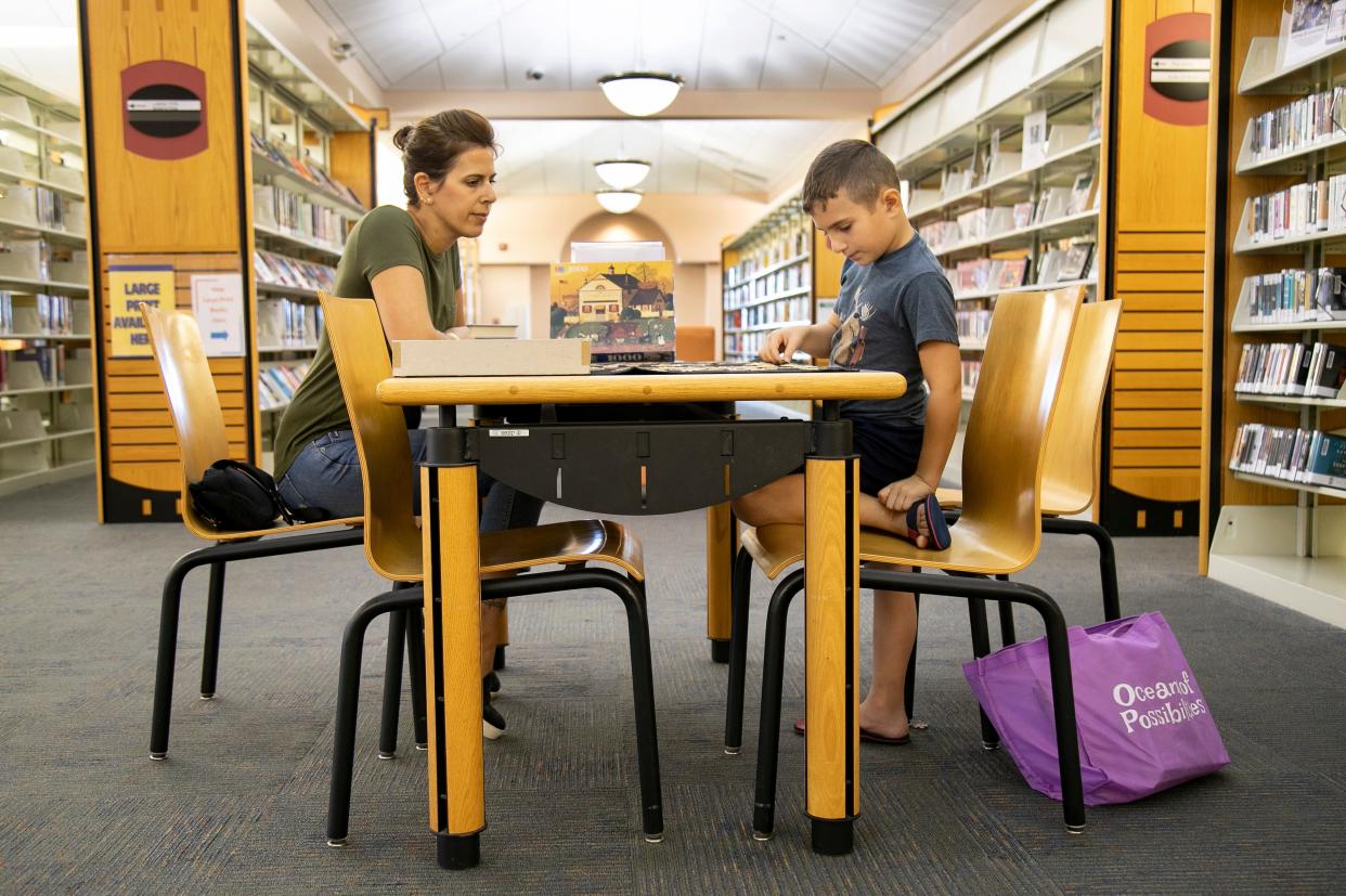 Maisa Zraik and her son Jason, 7, do a puzzle at the Cape Coral Public Library. Some of the furniture in the library was provided by the Friends of the Cape Coral library, a nonprofit organization that just celebrated its 50th anniversary.