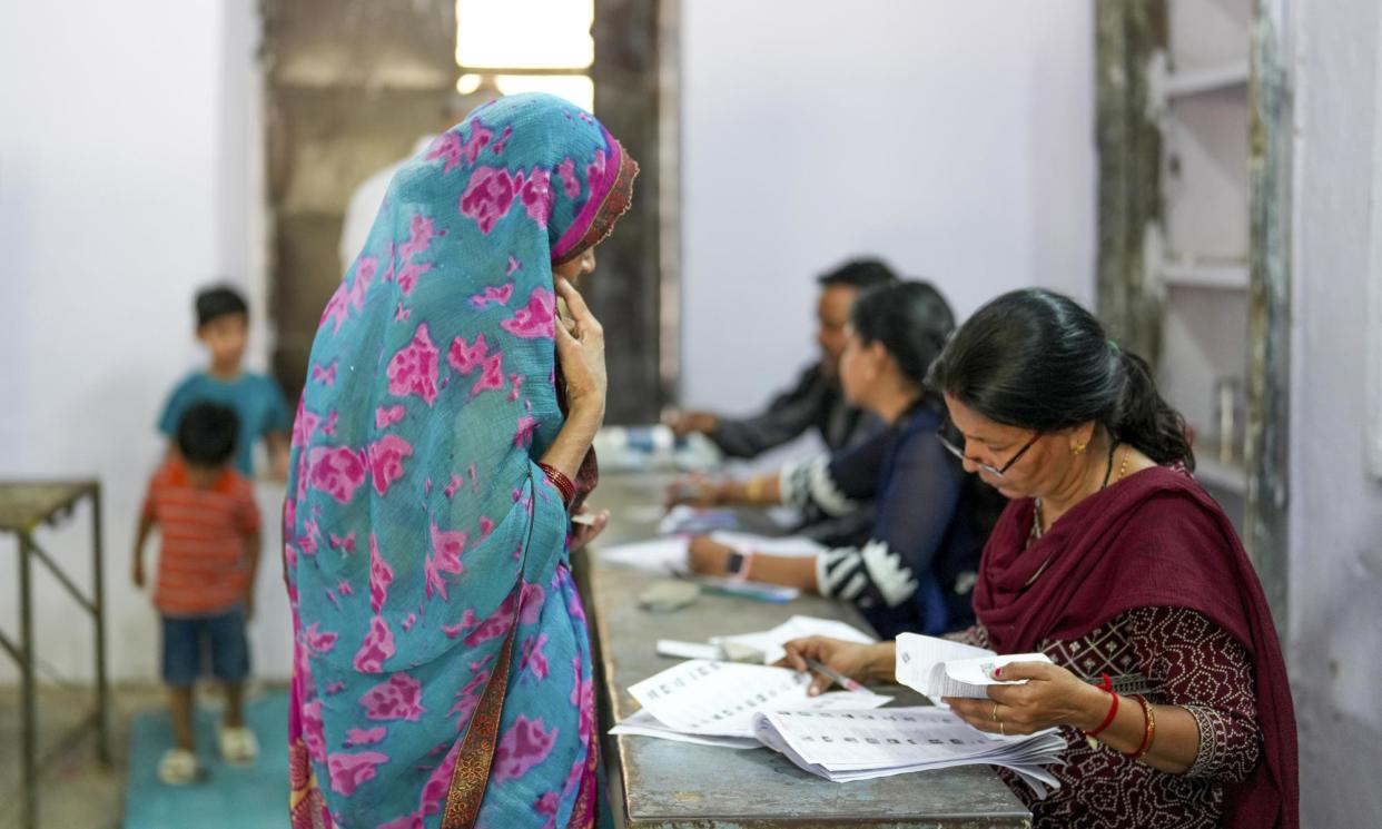 <span>A woman arrives to cast her vote at a polling station during the third phase of the India's general elections, in Ganeshpura, 7 May 2024.</span><span>Photograph: Anadolu/Getty Images</span>