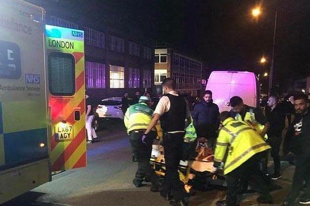 Police treat the injured after the hit-and-run at the Islamic centre