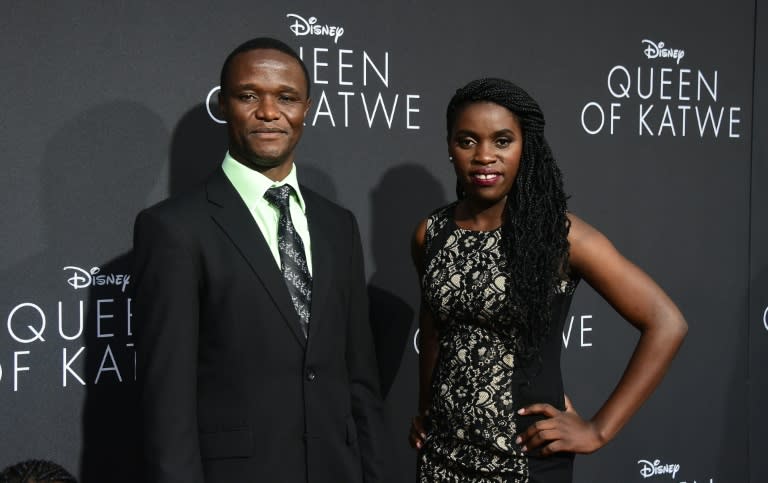 Robert Katende and Phiona Mutesi (R), whose life on which the story is based, pose on arrival for the premiere of Disney's "Queen of Katwe" in Hollywood, California on September 20, 2016