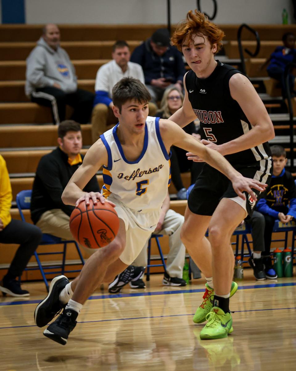 Jefferson's Michael Armetta,drives the baseline around Chad Martin of New Boston Huron during a 53-46 Jefferson victory Tuesday night.