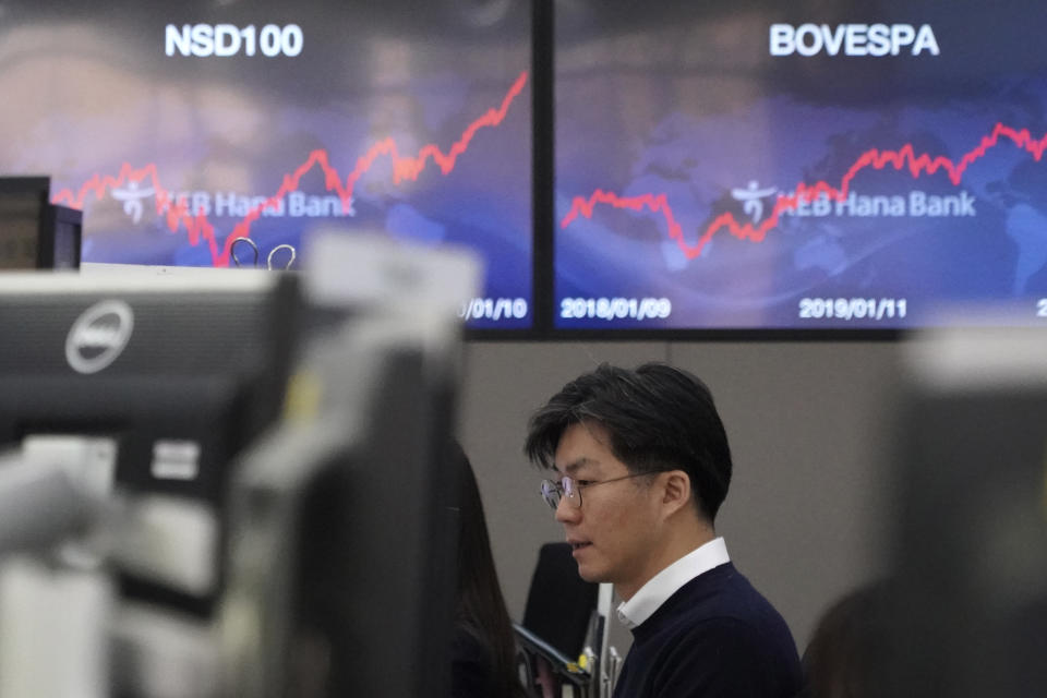 A currency trader watches computer monitors at the foreign exchange dealing room in Seoul, South Korea, Monday, Jan. 13, 2020. Asian stocks have risen as investors shrug off weaker-than-expected American jobs data and look ahead to the signing of a U.S.-China trade deal. Benchmarks in Shanghai, Hong Kong and Southeast Asia all advanced. (AP Photo/Lee Jin-man)