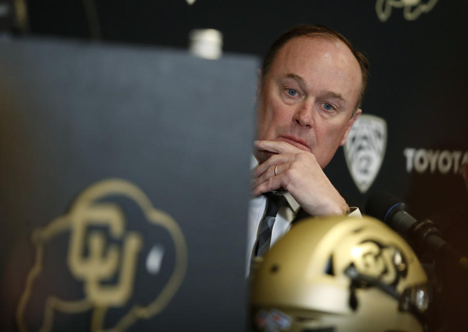 Colorado athletic director Rick George listens as Karl Dorrell talks at a news conference to announce that he is the new NCAA college head football coach at Colorado during a news conference Monday, Feb. 24, 2020, in Boulder, Colo. (AP Photo/David Zalubowski)