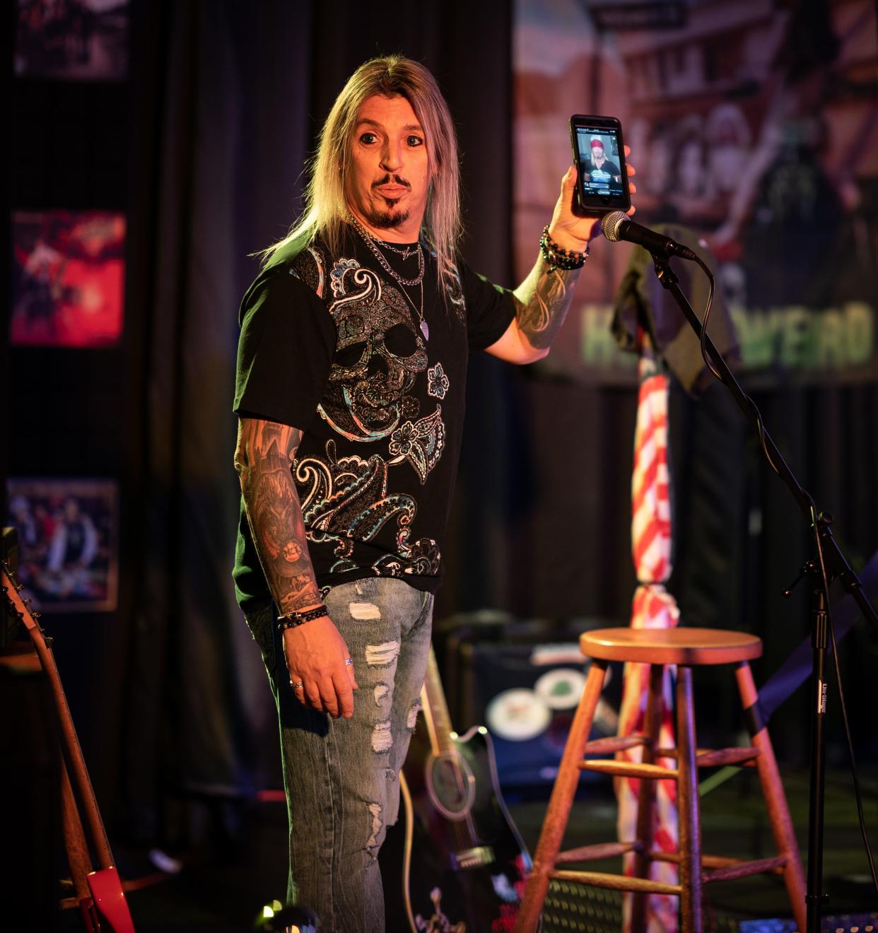 WORCESTER - Frank Pupillo, owner of Rascals on James Street and lead singer in the cover band “Shot of Poison,'' plays a video of Bret Michaels during a gathering at the club Wednesday evening.