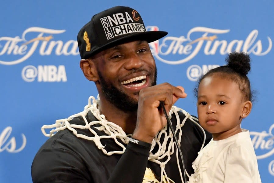 LeBron James #23 of the Cleveland Cavaliers holds his daughter Zhuri during a press conference after defeating the Golden State Warriors 93-89 in Game 7 to win the 2016 NBA Finals at ORACLE Arena on June 19, 2016 in Oakland, California. (Photo by Thearon W. Henderson/Getty Images)