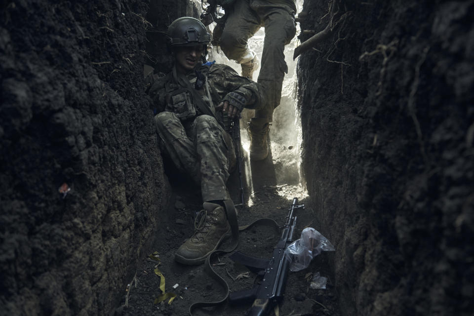 FILE - A soldier of Ukraine's 3rd Separate Assault Brigade jumps in a trench under the shelling near Bakhmut, the site of fierce battles with the Russian forces in the Donetsk region, Ukraine, on Sept. 4, 2023. Two years after Russia’s full-scale invasion captured nearly a quarter of the country, the stakes could not be higher for Kyiv. After a string of victories in the first year of the war, fortunes have turned for the Ukrainian military, which is dug in, outgunned and outnumbered against a more powerful opponent. (AP Photo/Libkos, File)