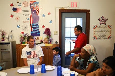 Walter Armando Jimenez Melendez, an asylum seeker from El Salvador, arrives with his four year-old son Jeremy at La Posada Providencia shelter in San Benito, Texas, U.S., shortly after he said they were reunited following 48 days of separation while in detention July 10, 2018. REUTERS/Loren Elliott