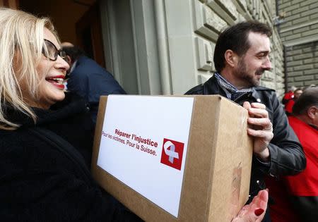 So called contract children, now adults, attend the initiative of seeking a restituition package in Bern December 19, 2014. A campaign seeking financial restitution for thousands of Swiss children, who were forced into foster families and used as cheap farming labour, has garnered the necessary support to force a national vote on the issue. REUTERS/Ruben Sprich