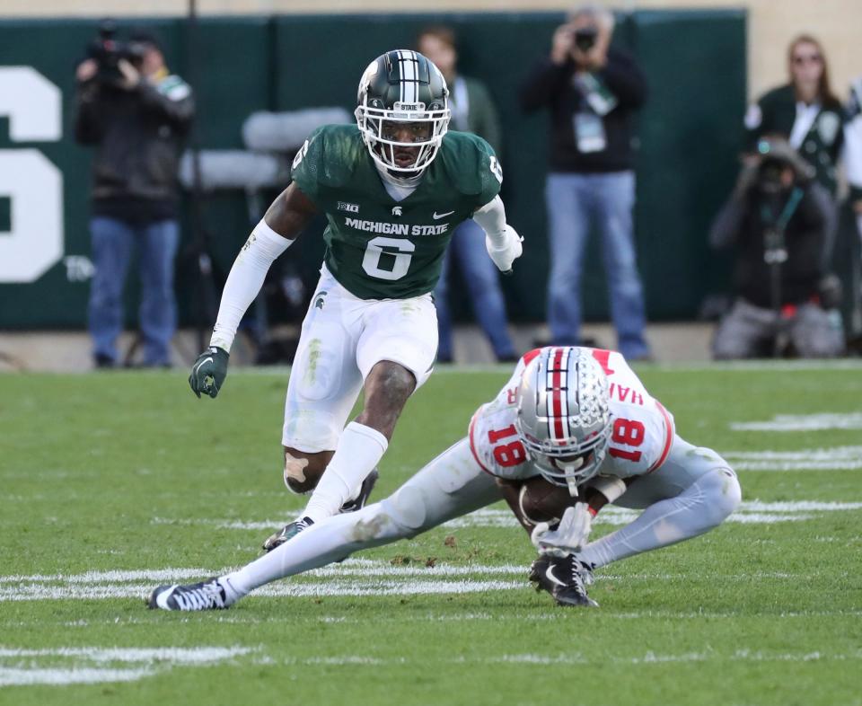 Ohio State Buckeyes wide receiver Marvin Harrison Jr. (18) catches a pass against Michigan State Spartans cornerback Charles Brantley (0) during second half action at Spartan Stadium Saturday, October 8, 2022.
