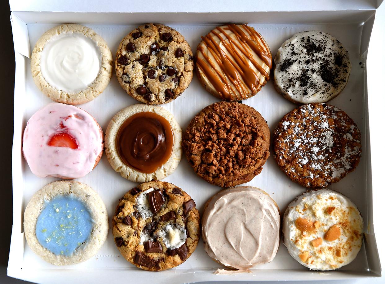 The sampler cookie box from Christine Pinson’s specialty cookie business, Hey Sugar Thursday. Top row, left; the Hey Sugar sugar cookie, the Classic Chocolate Chip cookie, the Cookie Butter cookie and the Cookies ’N Cream cookie. Second row, left; the Strawberry Cake cookie, the Twix cookie, the Coffee Cake cookie and the Gooey Butter Oatmeal cookie. Bottom row, left; the Lavender Haze cookie, the S’mores cookie; the Cinnamon Roll cookie, and the Banana Pudding cookie.