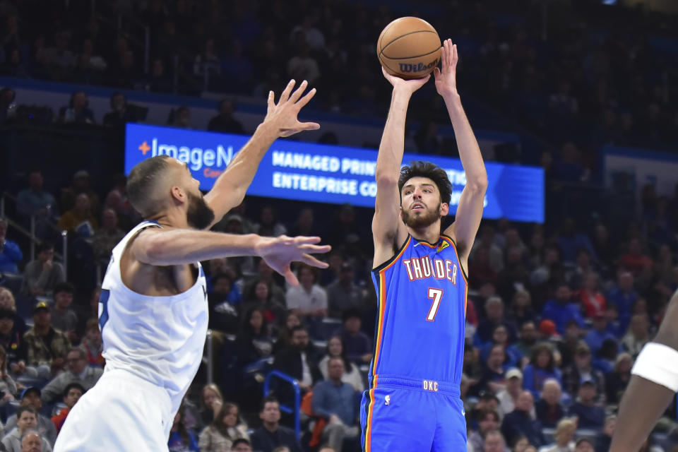 Oklahoma City Thunder forward Chet Holmgren shoots against Minnesota Timberwolves center Rudy Gobert during the second half of an NBA basketball game Tuesday, Dec. 26, 2023, in Oklahoma City. (AP Photo/Kyle Phillips)