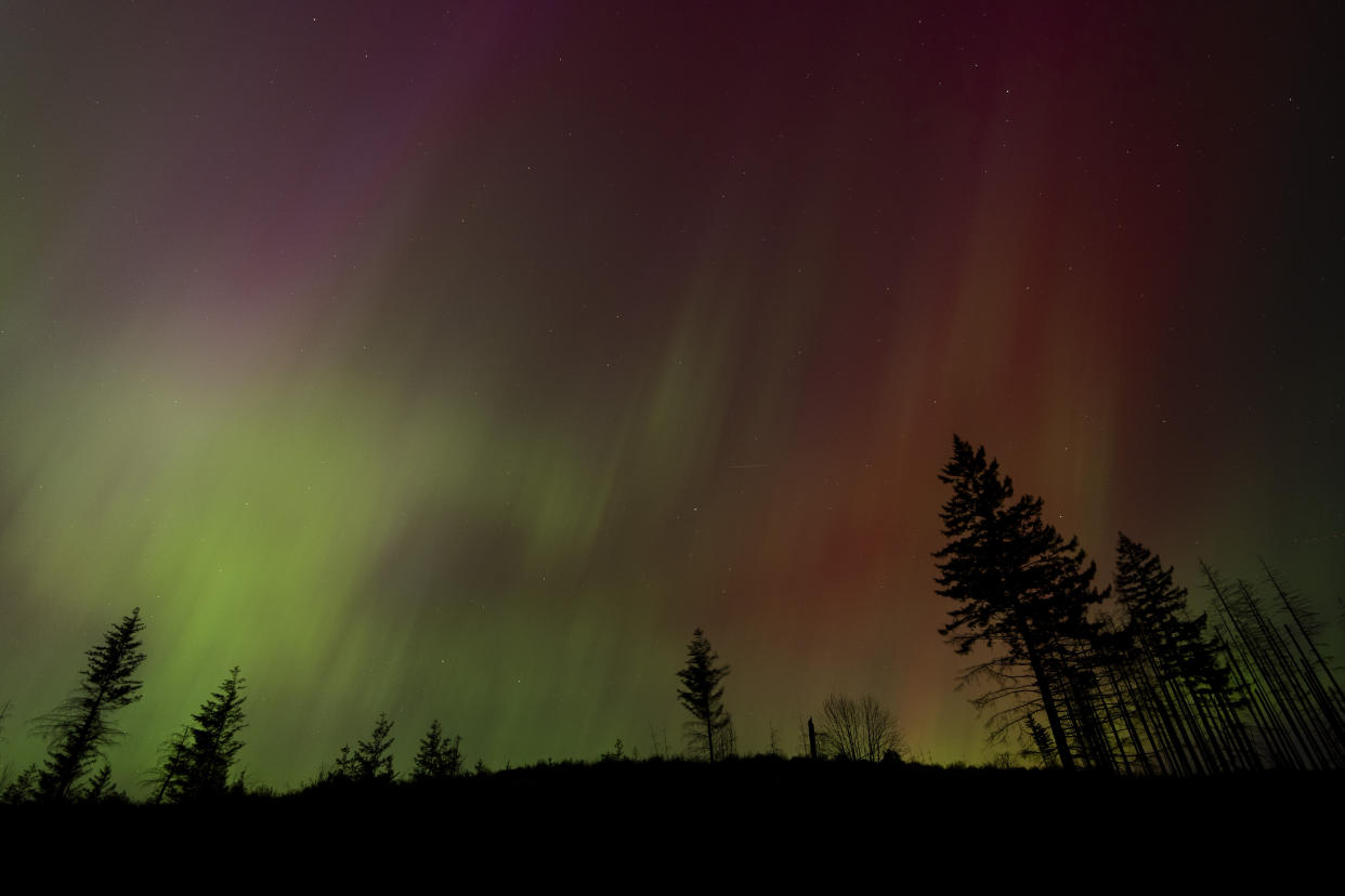 In this image taken with a long exposure, northern lights are seen in the sky on Friday, May 10, 2024, in Estacada, Ore. The National Oceanic and Atmospheric Administration issued a rare severe geomagnetic storm warning when a solar outburst reached Earth on Friday afternoon, hours sooner than anticipated. The effects were due to last through the weekend and possibly into next week. (AP Photo/Jenny Kane)