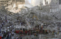 A fire engine is brought in to sift through the wreckage of one of the towers. (Caters)