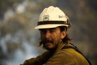 A firefighter looks on while defending the Mount Wilson Observatory in the Angeles National Forest during the Bobcat Fire in Los Angeles