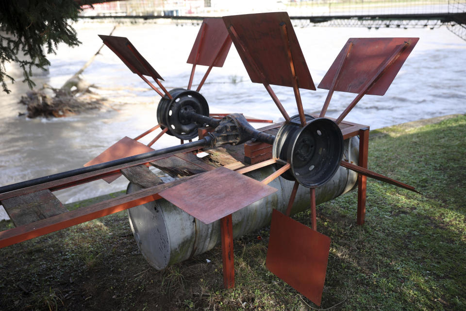 Improvised hydropower plant which now serves as a monument in seen on the bank of Drina river in Gorazde, Bosnia, Monday, Dec. 19, 2022. To survive and keep the lights on in their besieged town - cut off throughout Bosnia's 1992-95 interethnic war from access to electricity grid, food, medicine and the outside world - the people of Gorazde had to come up with various creative inventions. (AP Photo/Armin Durgut)