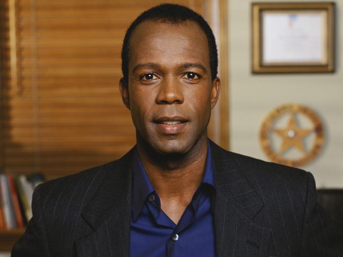 Clarence Gilyard, Jr. in a black jacket and blue shirt