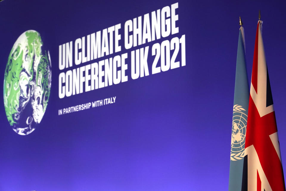 The flags of Britain and the U.N. stand next to each other in the conference room before the Procedural Opening of the COP26 U.N. Climate Summit in Glasgow, Scotland, Sunday, Oct. 31, 2021. The U.N. climate summit in Glasgow formally opens Sunday, a day before leaders from around the world gather in Scotland's biggest city to lay out their vision for addressing the common challenge of global warming. (AP Photo/Alberto Pezzali, Pool)