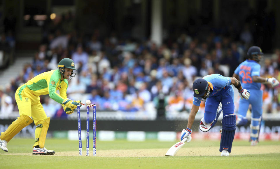 India's Virat Kohli survives a run out appeal against Australia's wicketkeeper Alex Carey during the Cricket World Cup group stage match at The Oval in London, Sunday June 9, 2019. (Nigel French/PA via AP)