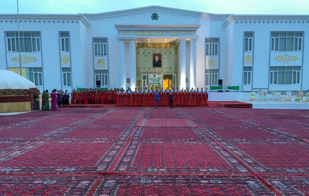 Artists performs in front of a polling station during a parliamentary election in Ashgabat, Turkmenistan March 25, 2018. REUTERS/Marat Gurt