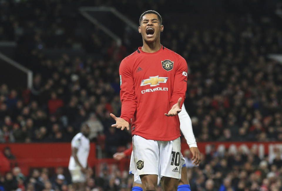 FILE - In this Wednesday, Dec. 18, 2019 file photo Manchester United's Marcus Rashford, reacts during the English League Cup quarter final soccer match between Manchester United and Colchester United at Old Trafford in Manchester, England. British Prime Minister Boris Johnson made an abrupt about-face Tuesday June 16, 2020 and agreed to keep funding meals for needy pupils over the summer holidays, after a campaign headed by young soccer star Marcus Rashford. The Manchester United and England player has been pressing the government not to stop a meal voucher program at the end of the school term in July. (AP Photo/Jon Super, File)