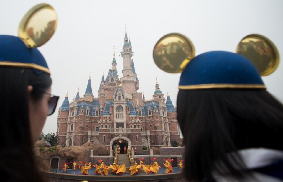 Women wearing Mickey Mouse ears last year at China's Shanghai Disney Resort where turkey legs slathered in hoisin sauce have become a surprise favorite menu item (AFP Photo/JOHANNES EISELE)