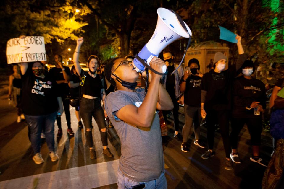 Thundasia Turner leads a chant in front of First Unitarian Church on Sunday, Sept. 27, 2020, in downtown Louisville.