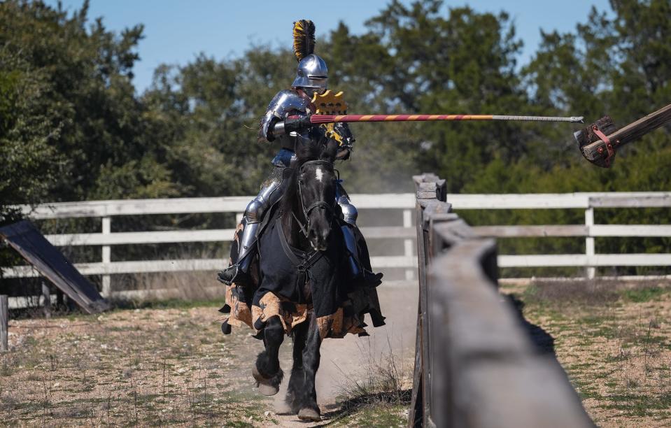 Jouster Raven Eastwood takes a practice run while riding horse Tinkerbell. The goal of the drill is to hit a small metal bolt on the target across the center rail, called a tilt, from the jouster, which mimics the small target jousters aim for on their opponents' shield in a real competition.