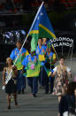 Solomon Islands' flagbearer Jenly Tega Wini leads her delegation in the opening ceremony of the London 2012 Olympic Games in the Olympic Stadium in London on July 27, 2012. AFP PHOTO / CHRISTOPHE SIMONCHRISTOPHE SIMON/AFP/GettyImages