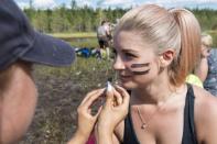 Players of SuoSiat get a war paint on their faces before the game at the Swamp Soccer World Championships tournament in Hyrynsalmi, Finland July 13, 2018. Picture taken July 13, 2018. Lehtikuva/Kimmo Rauatmaa/via REUTERS