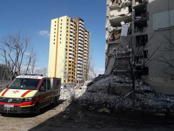 An ambulance stands ready by a damaged residential building after a Russian attack in Chernihiv, Ukraine on March 17, 2022.