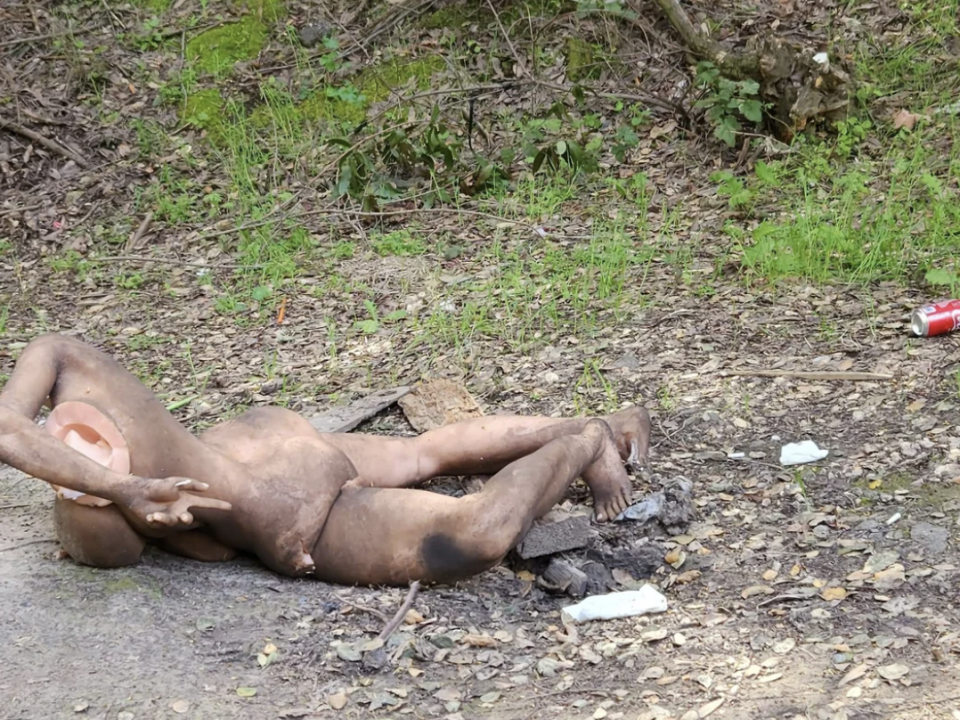 A destroyed mannequin on the side of a road