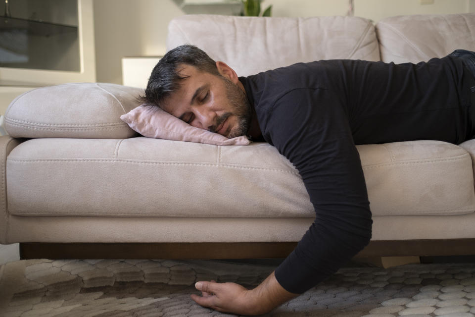 man asleep on a couch