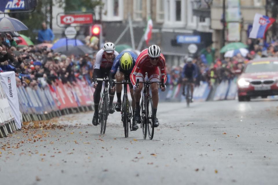 Denmark's Mads Pedersen sprints ahead of Italy's Matteo Trentin and Switzerland's Stefan Kung to win the men elite race, at the road cycling World Championships in Harrogate, England, Sunday, Sept. 29, 2019. (AP Photo/Manu Fernandez)