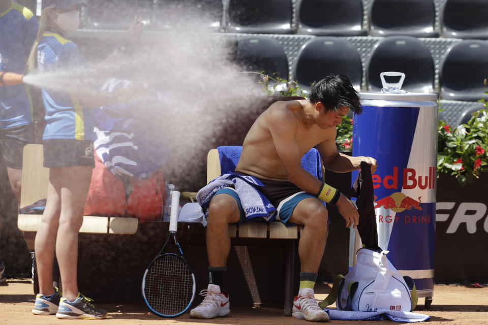 Japan's Kei Nishikori changes his shirt during a match against Italy's Fabio Fognini at the Italian Open tennis tournament, in Rome, Monday, May 10, 2021. (AP Photo/Gregorio Borgia)